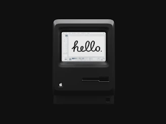 A cozy computer screen showing the phrase 'Hello World' in colorful text.