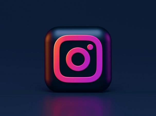 A 3D representation of the Instagram logo with neon pink and purple colors on a dark background.