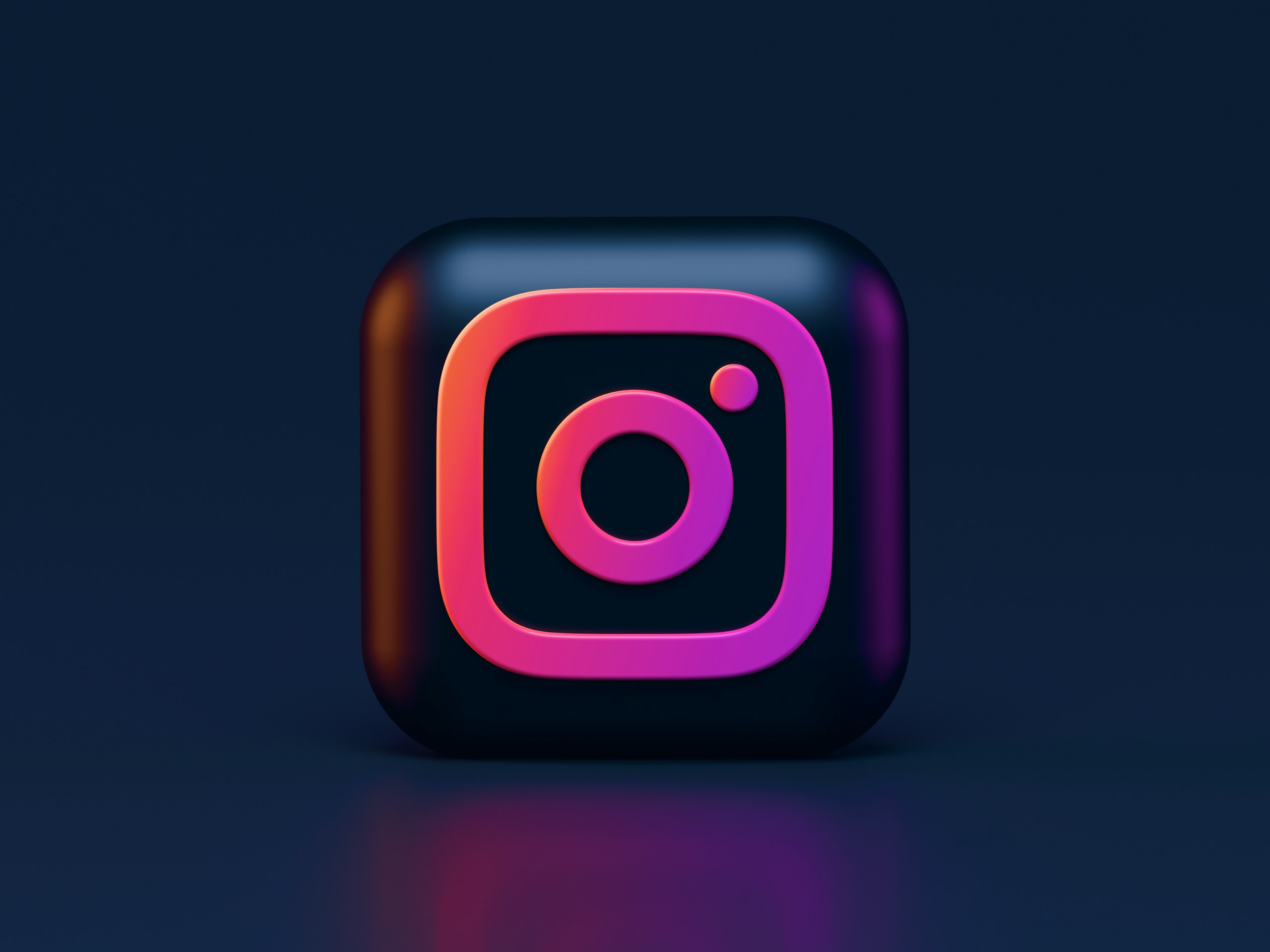 Instagram's logo appearing on a dark 3D shape