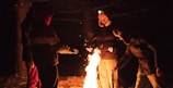 A group of hunters discussing strategies around a campfire.