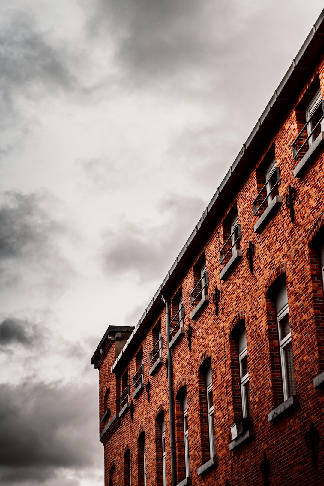 brown concrete building under cloudy sky during daytime