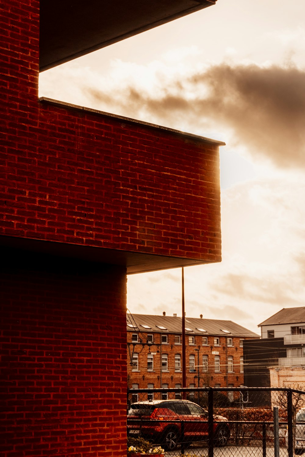 brown brick building under cloudy sky during daytime