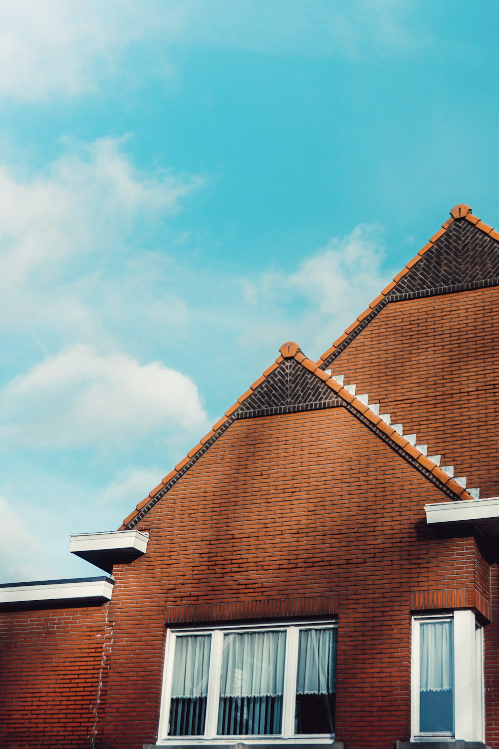 brown brick house under blue sky during daytime