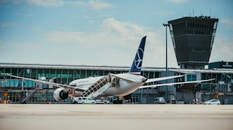 white and blue airplane on airport during daytime