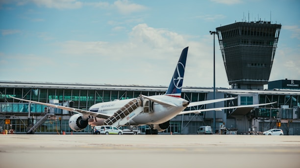 white and blue airplane on airport during daytime