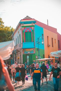 people in front of brown concrete building during daytime