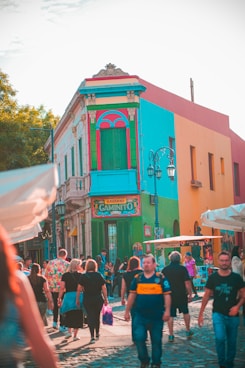 people in front of brown concrete building during daytime