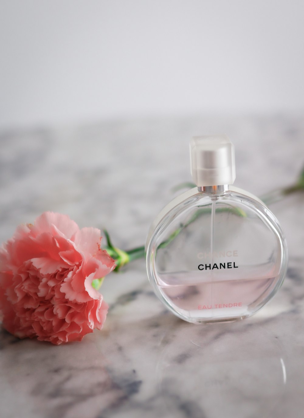 pink rose on clear glass bottle