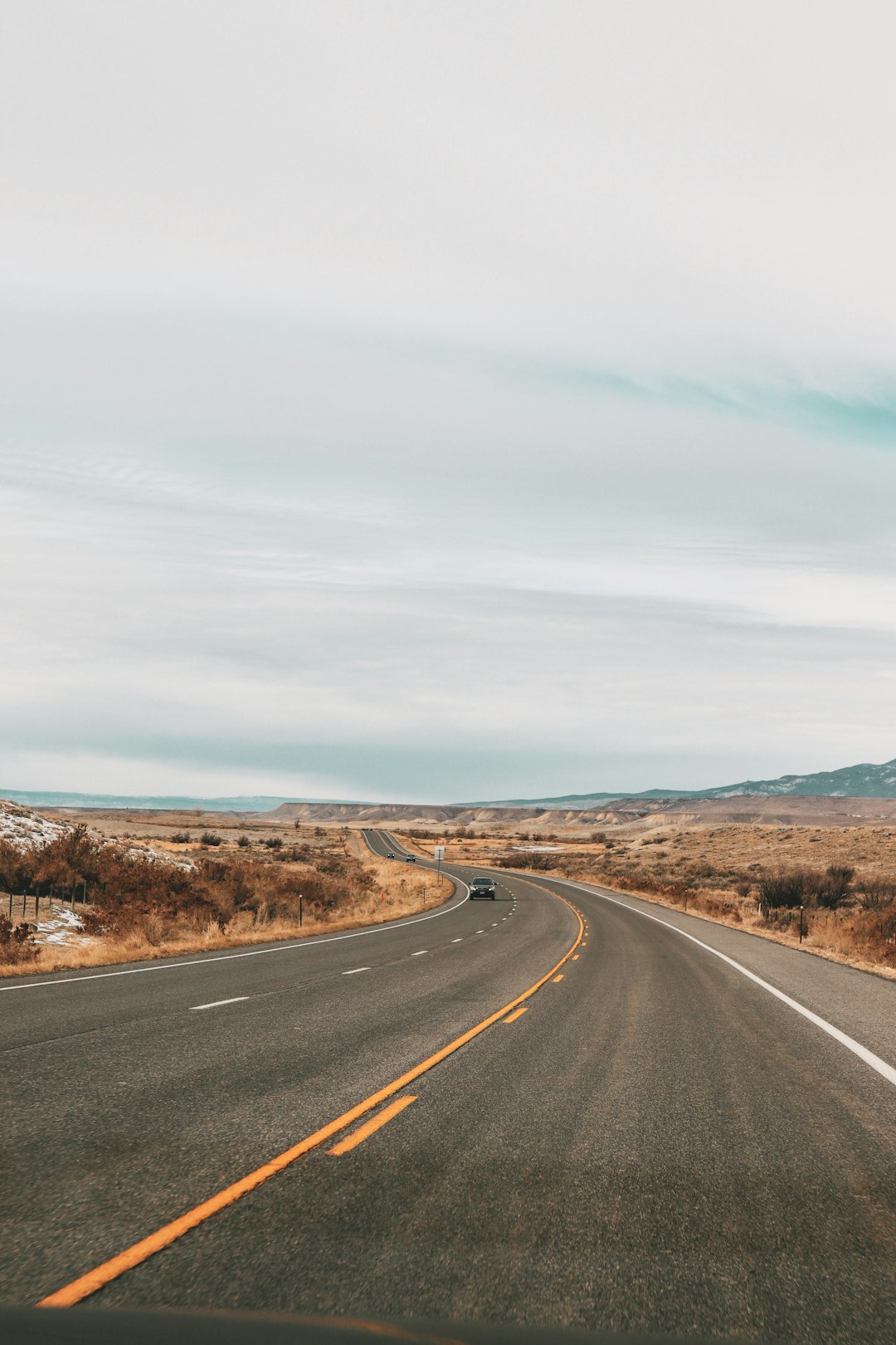 gray asphalt road under blue sky during daytime