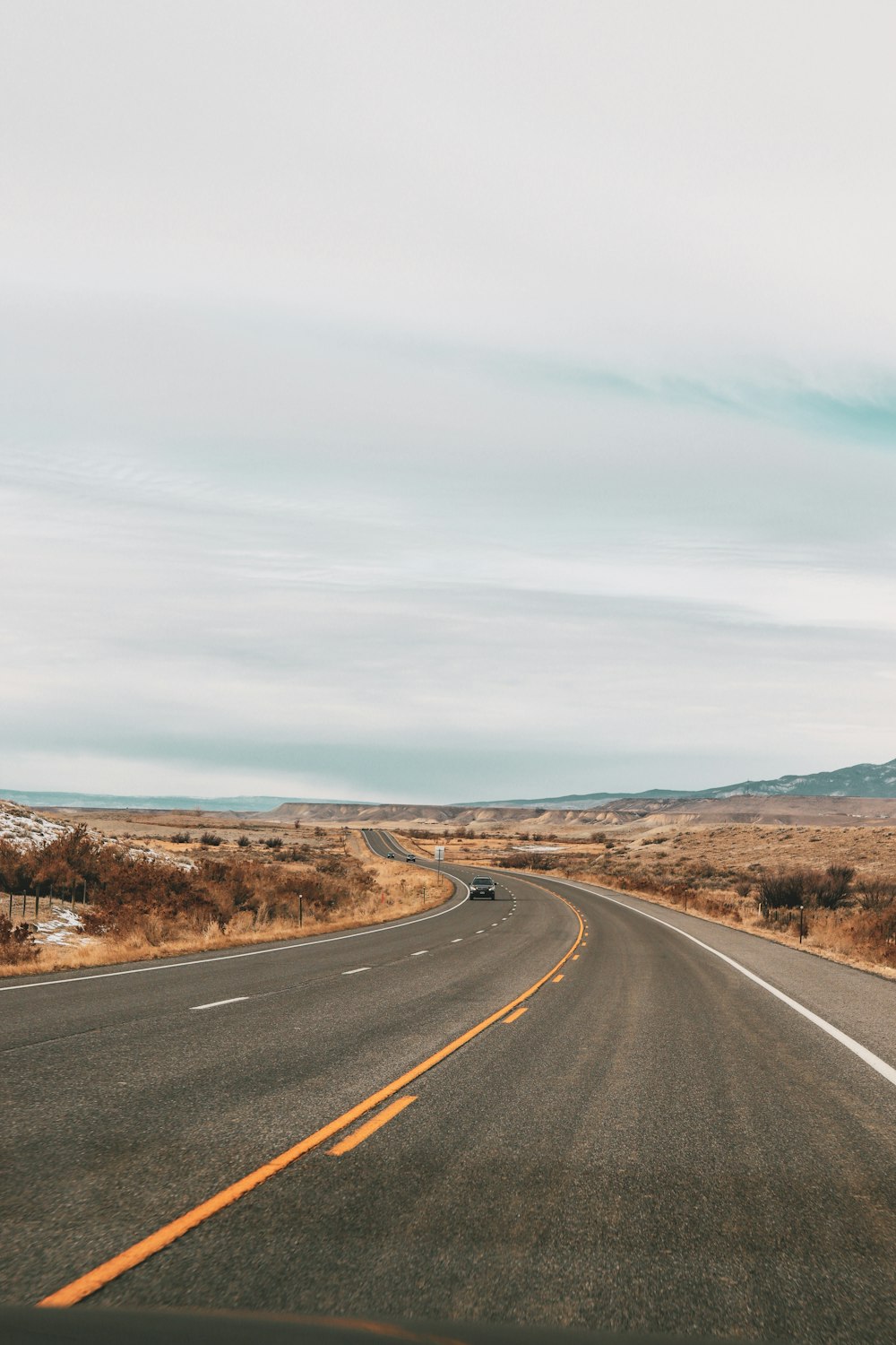 gray asphalt road under blue sky during daytime