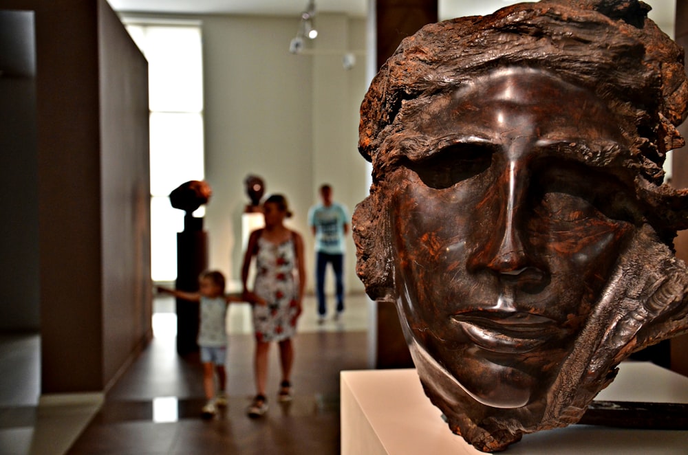 brown wooden human face bust