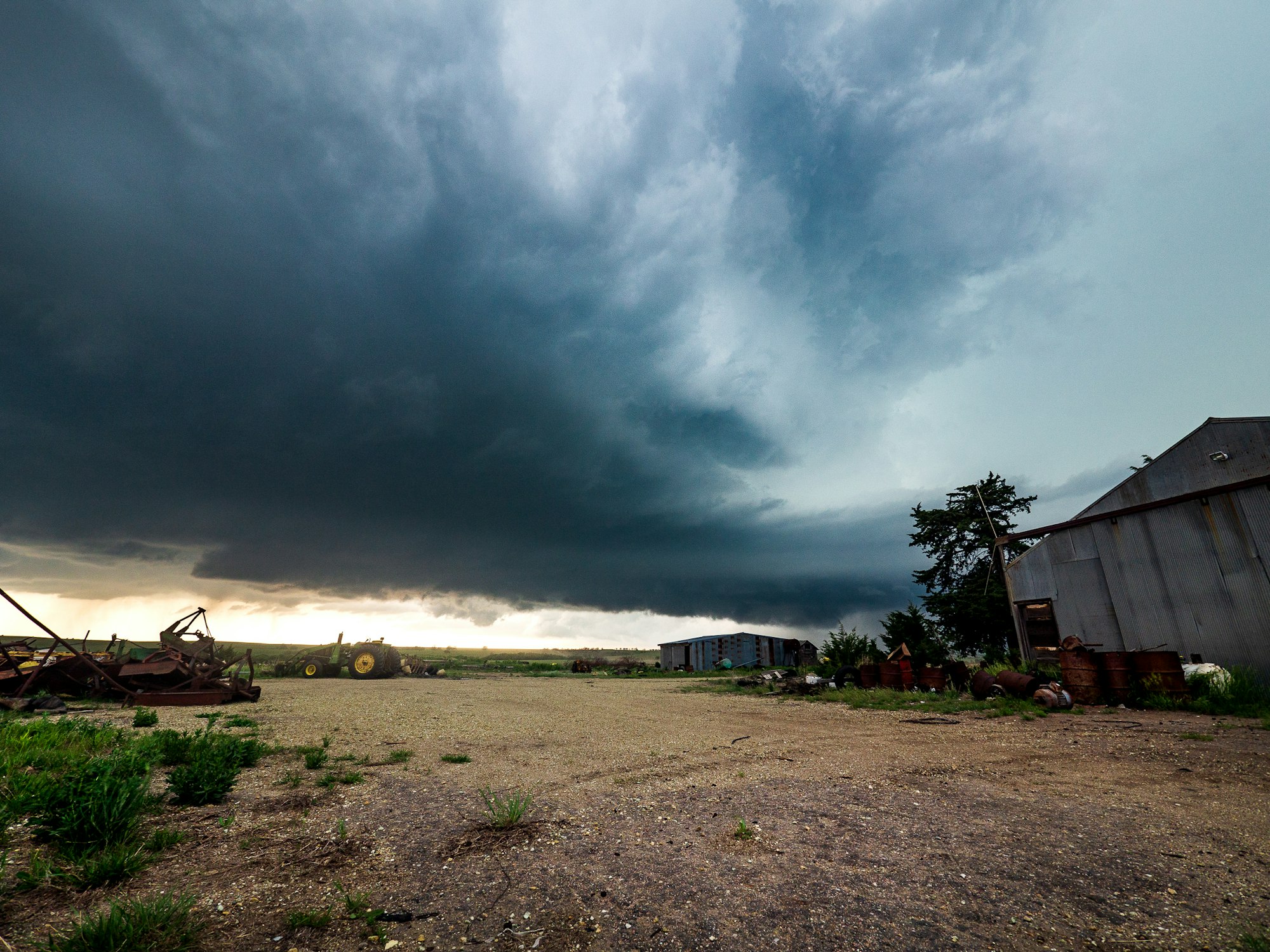 Supercell thunderstorm behind a farmyard in Kansas.
