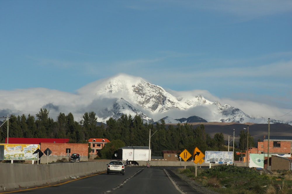 white van on road near snow covered mountain during daytime