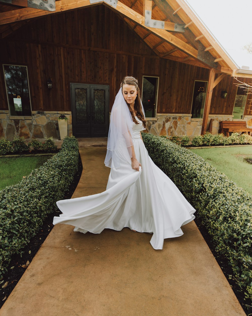 woman in white dress standing on brown concrete floor