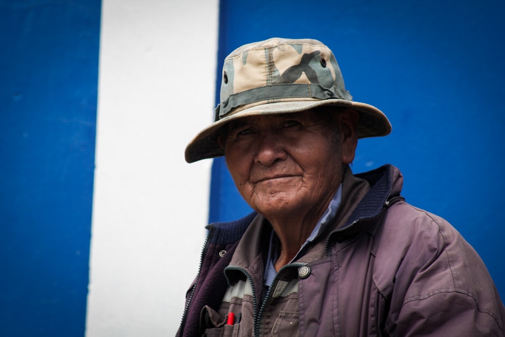 man in black jacket wearing brown hat