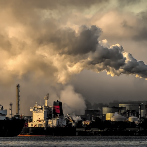 white and black ship on sea under white clouds