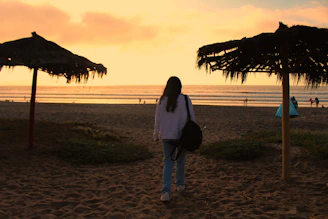 A friendly tour guide welcoming visitors at a beautiful Lombok beach during sunset.