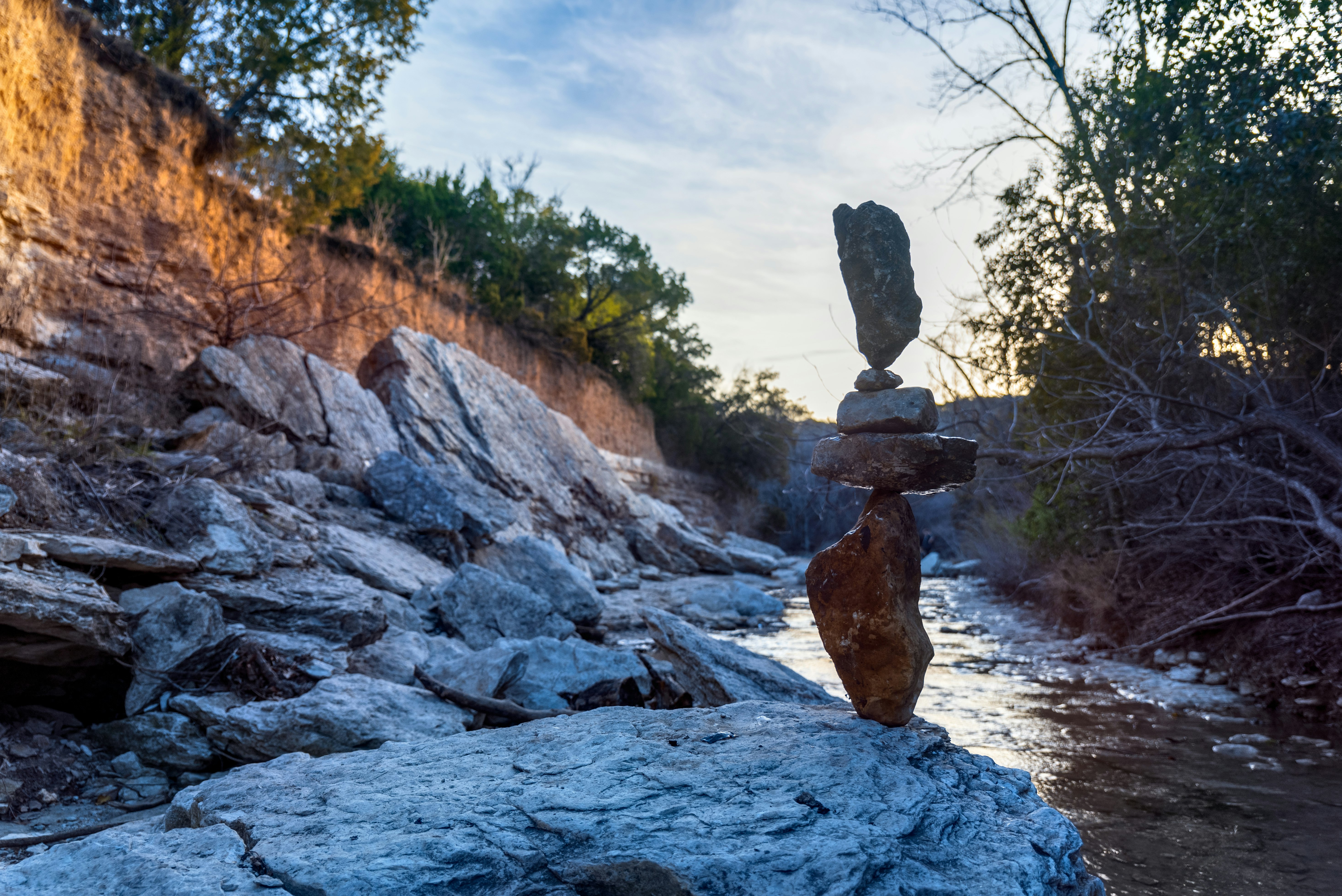 brown rock formation on river during daytime