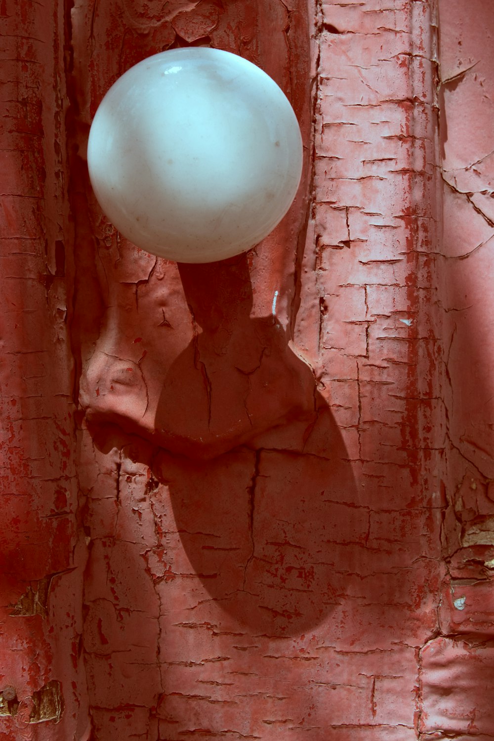 white balloon on brown concrete wall