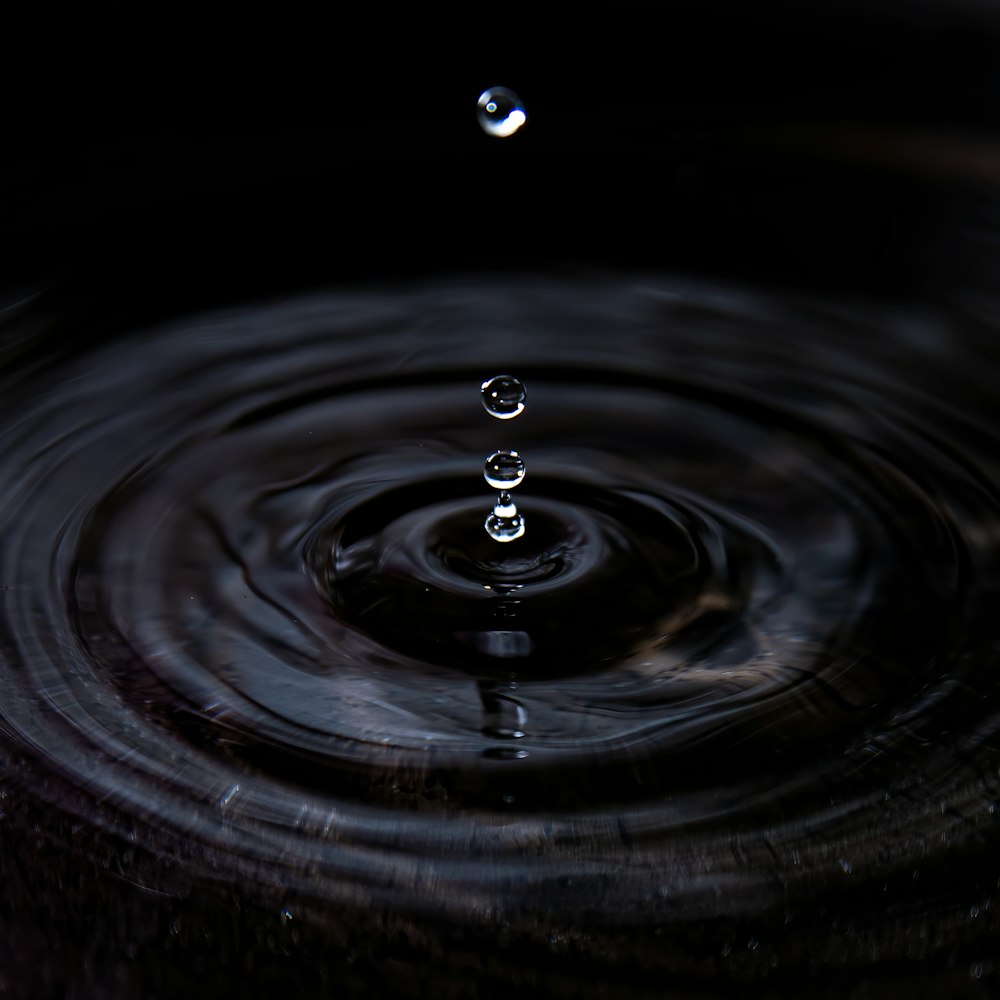 Water drop on black surface photo – Free Water Image on Unsplash