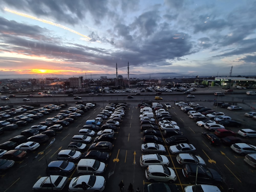 cars parked on parking lot during sunset