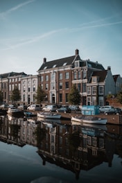 white and brown concrete building near body of water during daytime