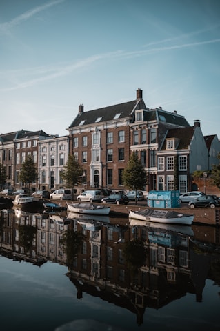white and brown concrete building near body of water during daytime