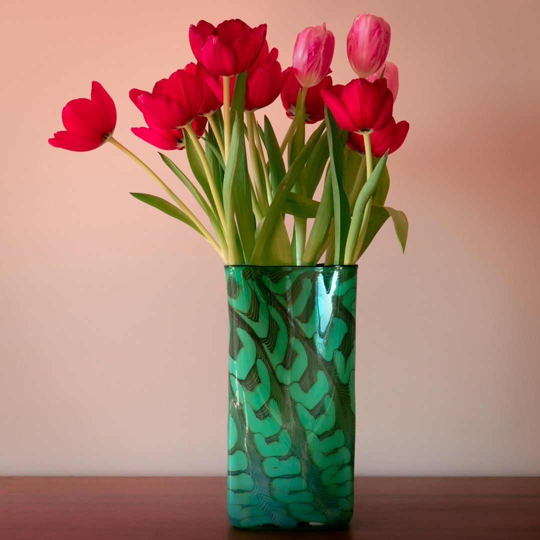 red tulips in blue glass vase
