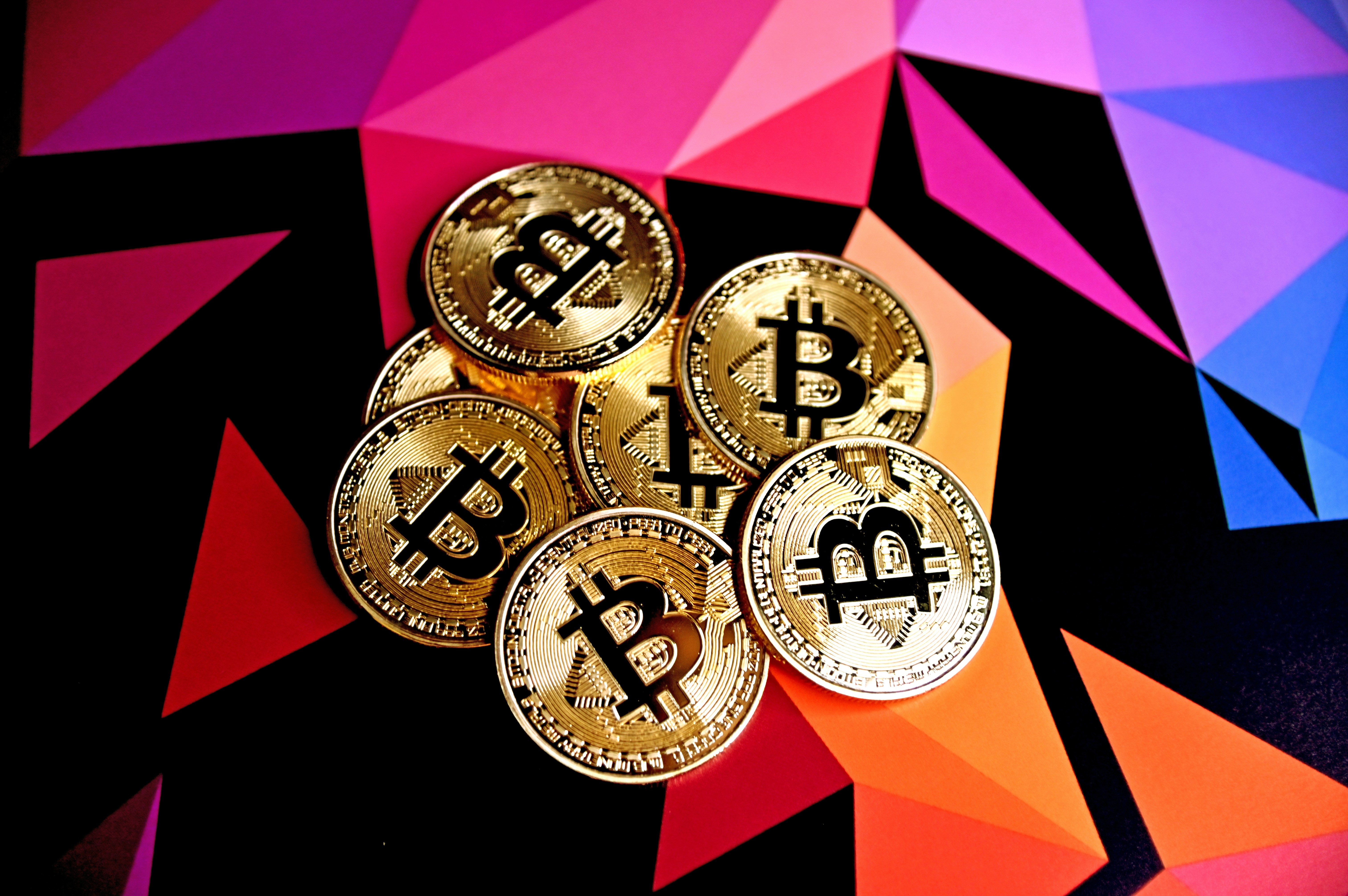 Bitcoins on a multi-colored background.