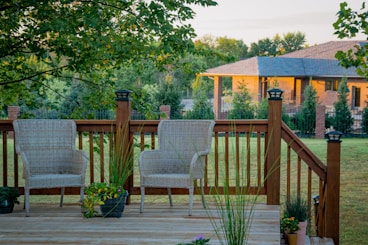 brown wooden fence near green trees during daytime
