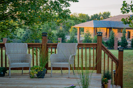 brown wooden fence near green trees during daytime