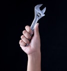 person holding gray and black metal tool