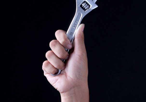 person holding gray and black metal tool