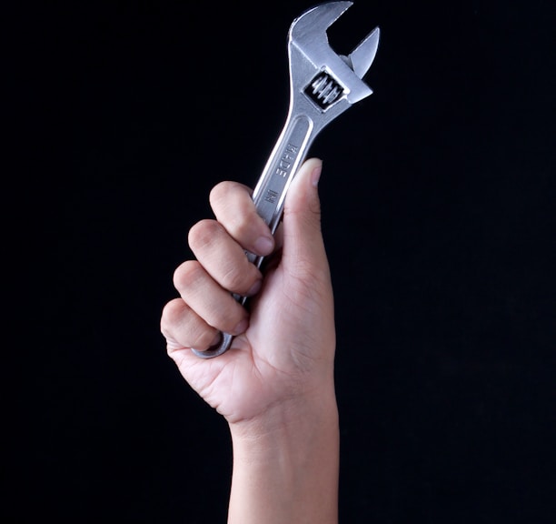 person holding gray and black metal tool