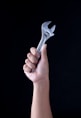 person holding gray and black metal tool