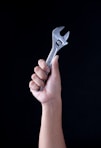 person holding gray and black metal tool