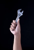 person holding gray and black metal tool