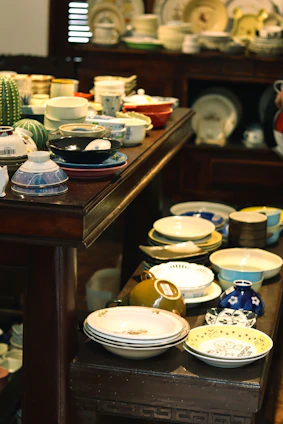 white and blue floral ceramic bowls on brown wooden table