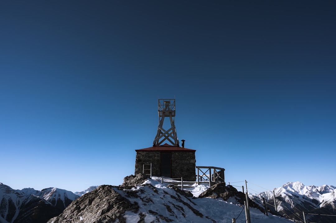 red and white tower on top of mountain