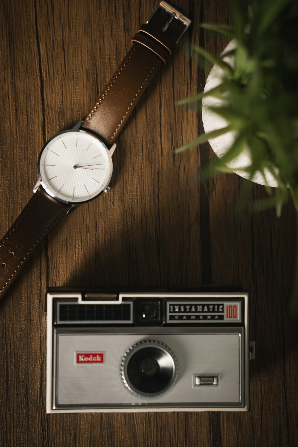 brown leather strap silver round analog watch