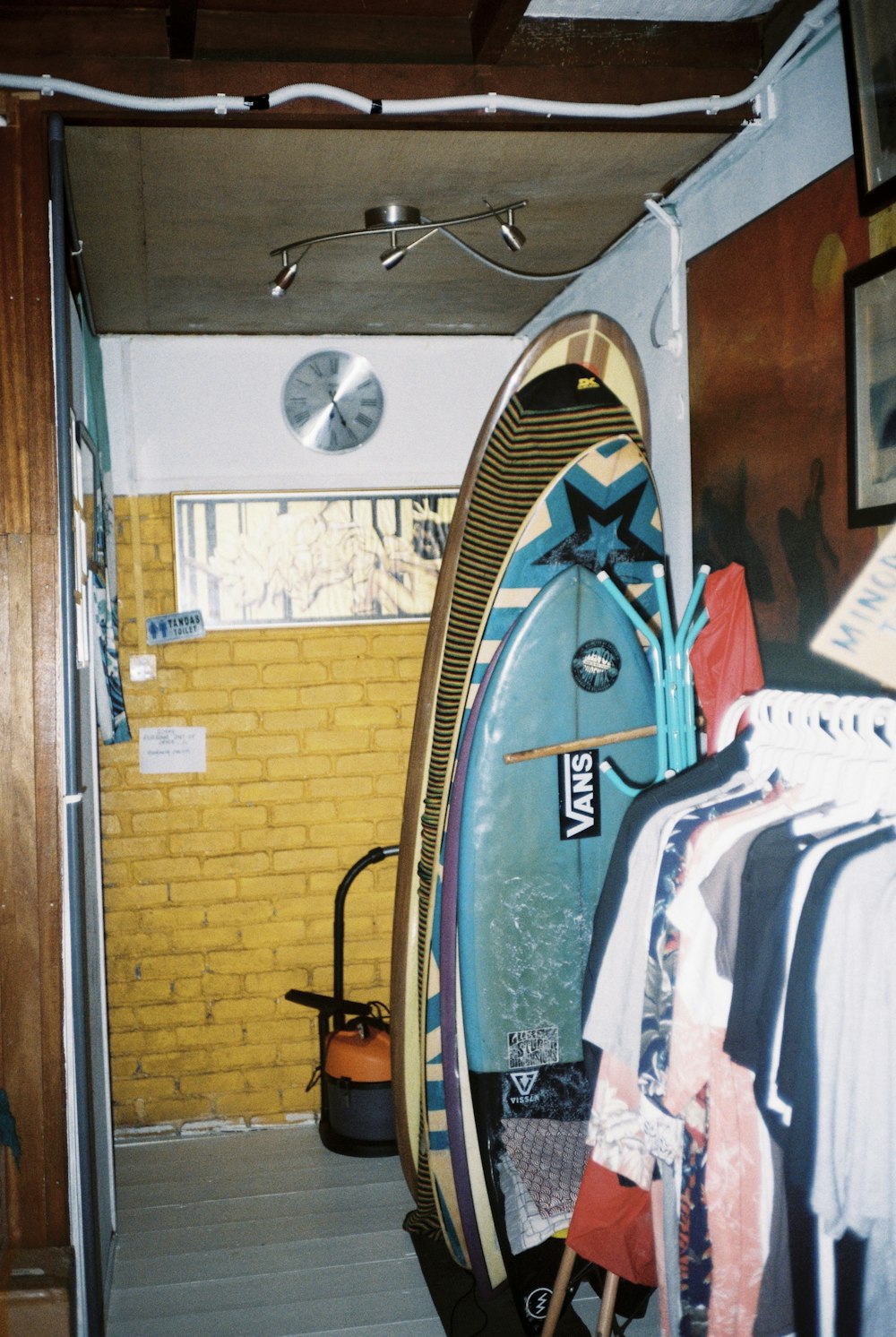 blue and white jacket hanging on door