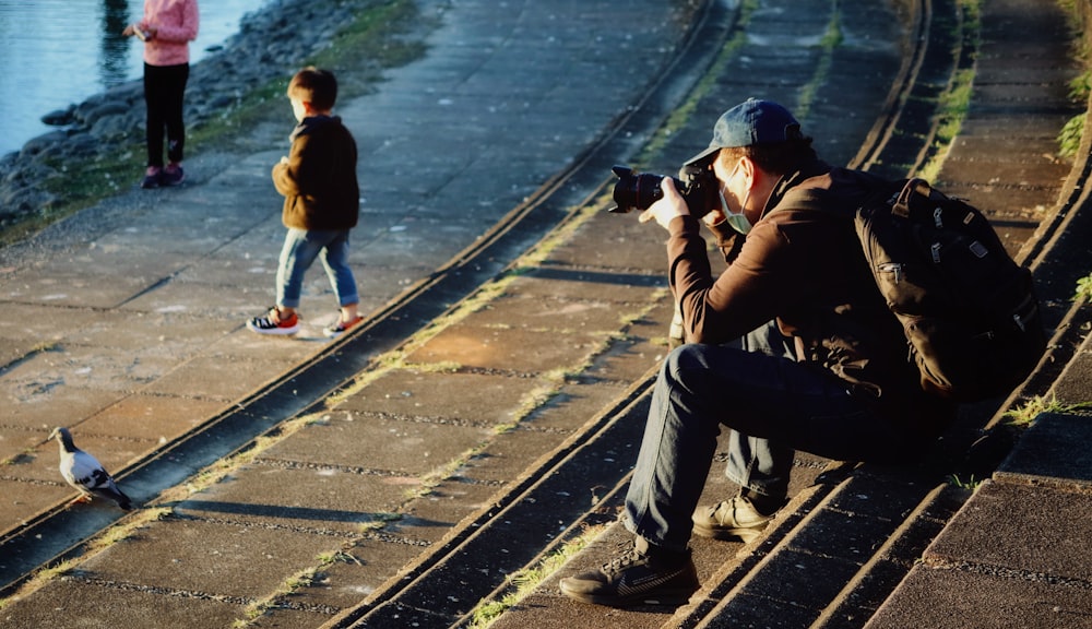 man in black jacket taking photo of man in black jacket