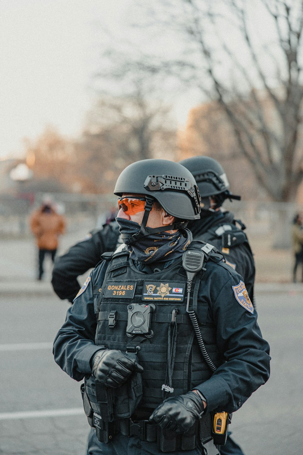 man in black police uniform wearing helmet standing on road during daytime