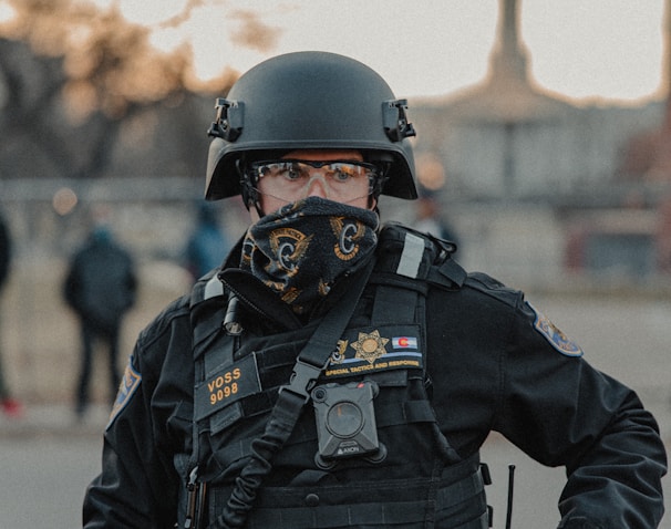 man in black police uniform wearing helmet