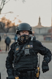 man in black police uniform wearing helmet