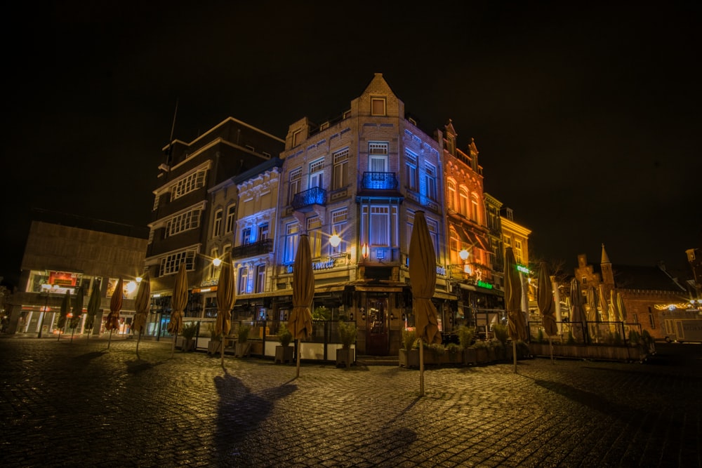 people walking on street near building during night time