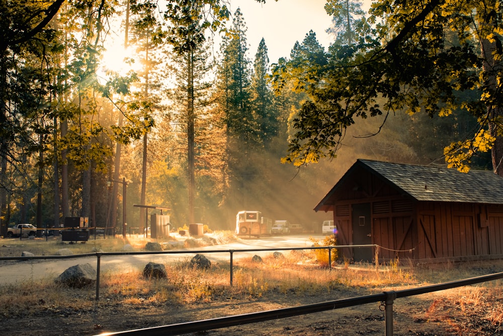 brown wooden house near green trees during daytime