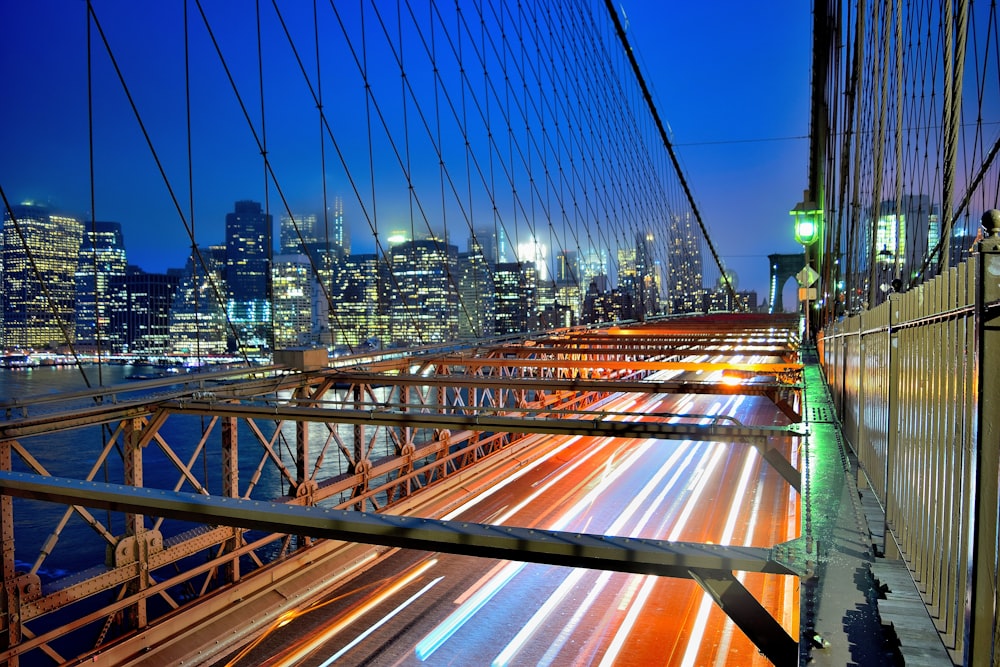 time lapse photography of cars on bridge during night time