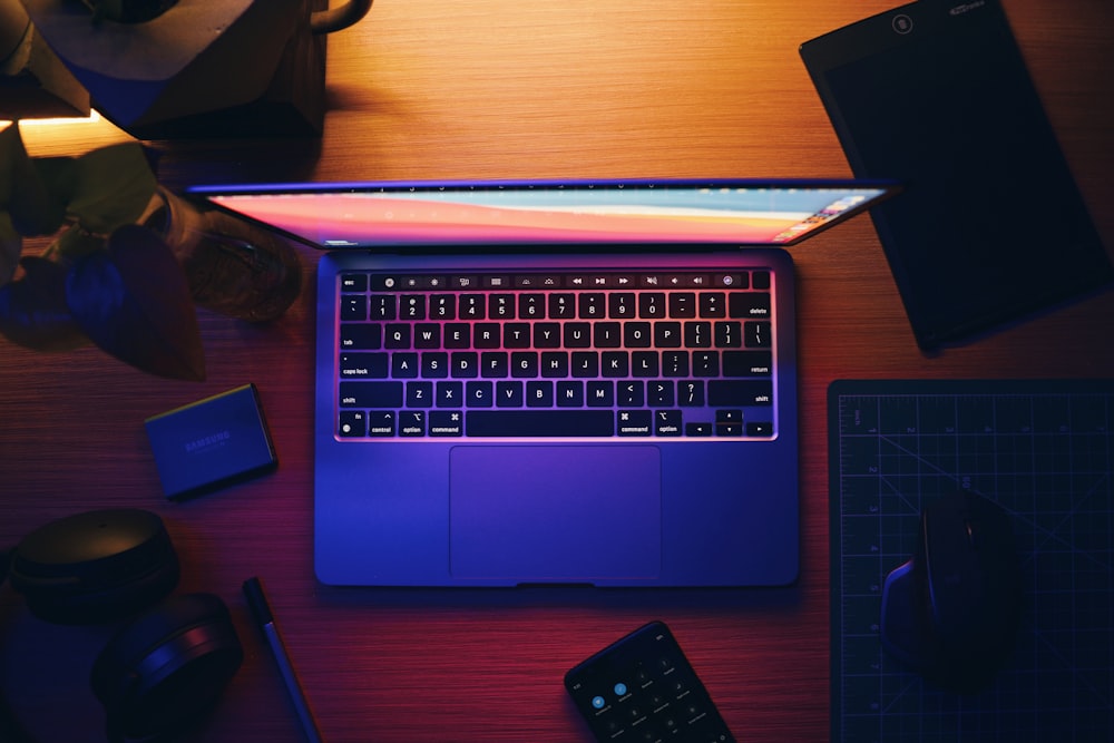 macbook pro on brown wooden table