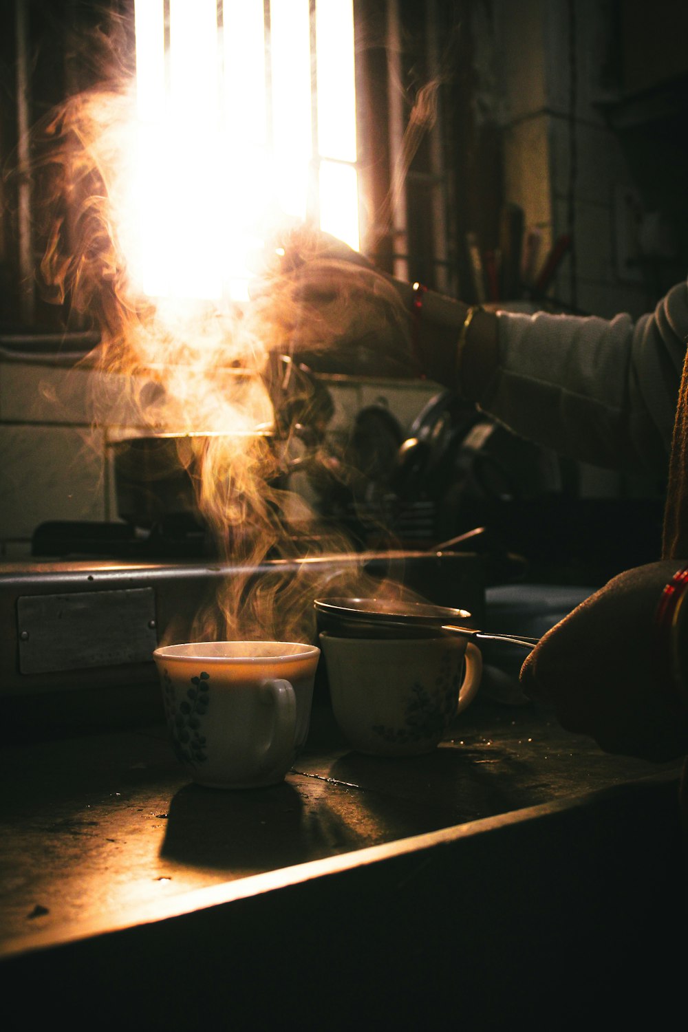 person in gray jacket holding white ceramic bowl